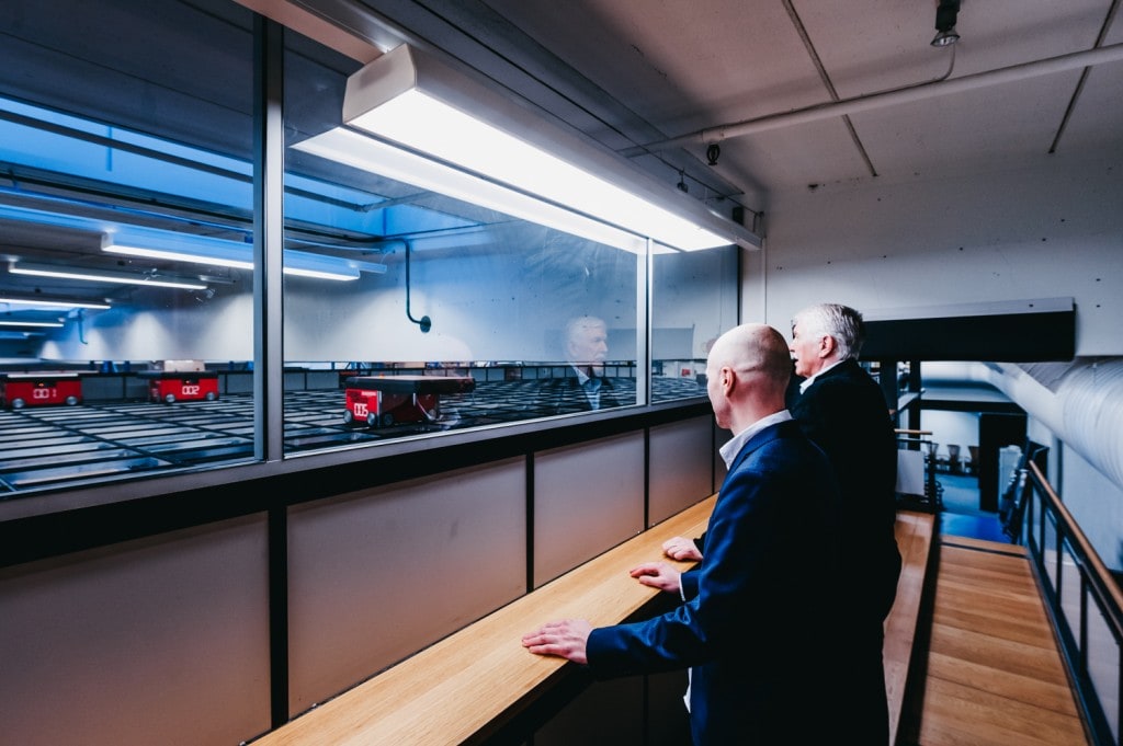 Jan Kleven and Roger Furnes look out at the AutoStore-robots on the grid.